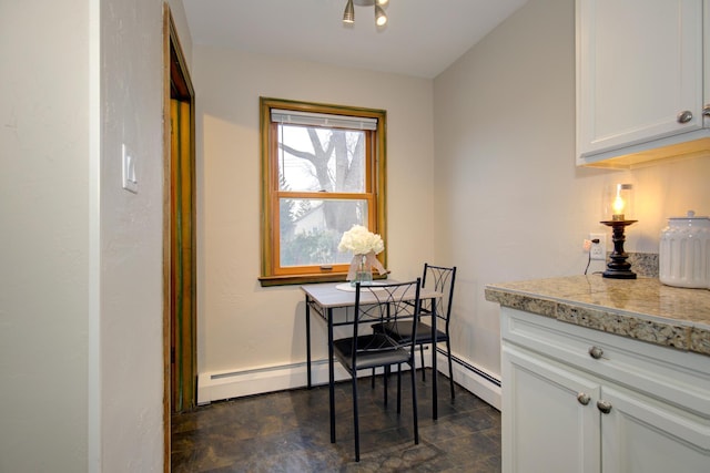dining room with baseboard heating and baseboards