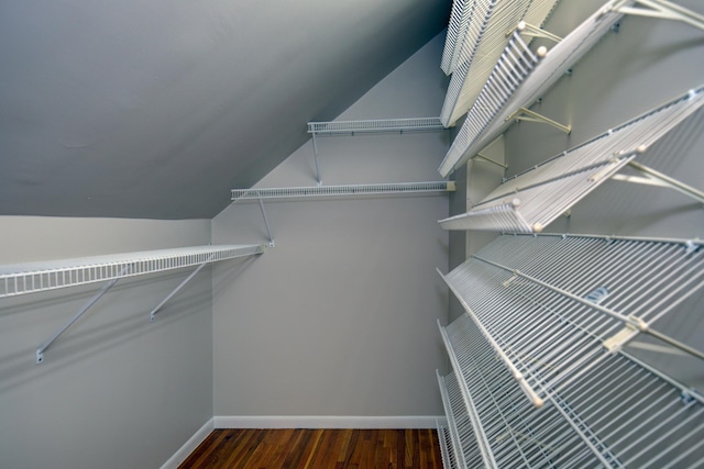 spacious closet featuring wood finished floors and lofted ceiling