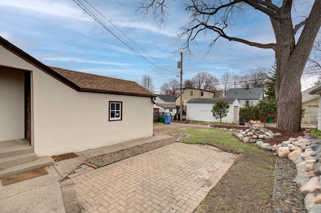 view of yard featuring a patio and an outdoor structure