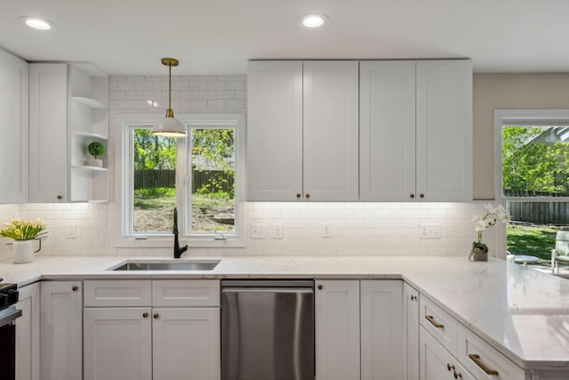 kitchen with stainless steel dishwasher, a sink, open shelves, white cabinets, and decorative backsplash