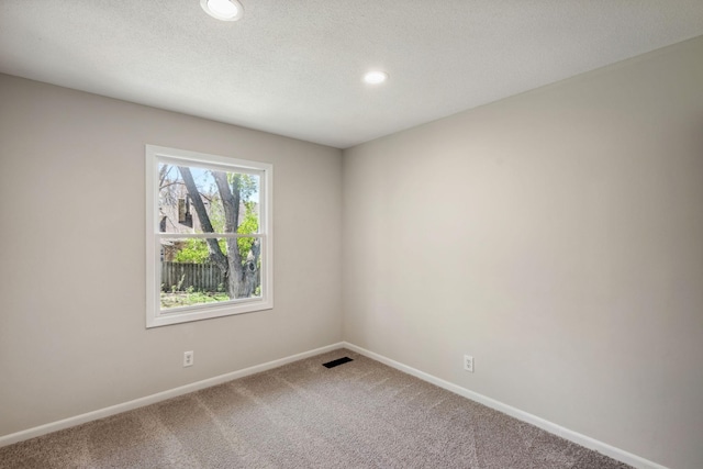spare room with carpet flooring, baseboards, and recessed lighting