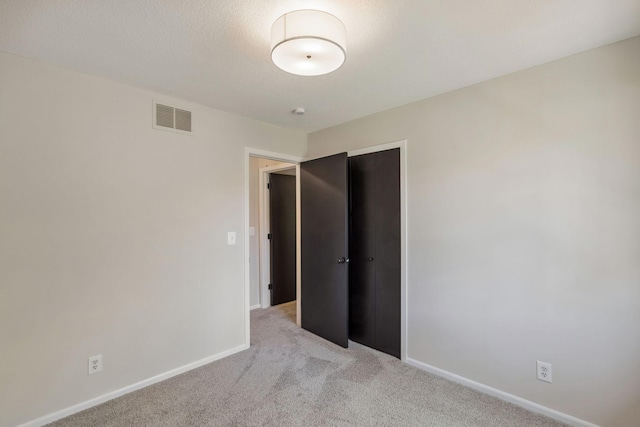 empty room with carpet and baseboards