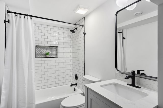 bathroom featuring toilet, shower / bath combo with shower curtain, and vanity