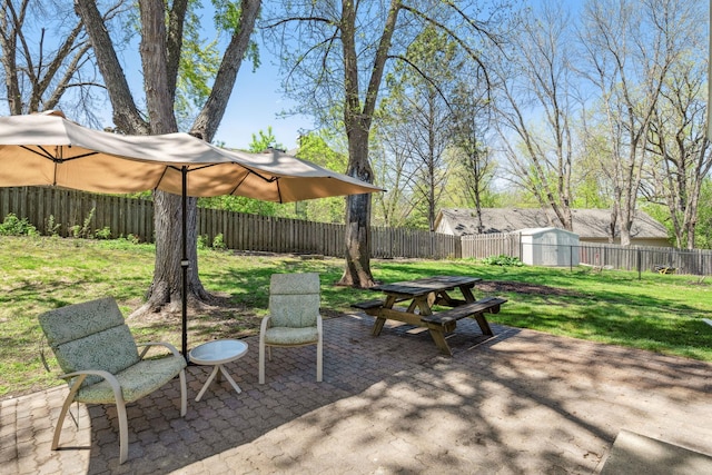 view of patio / terrace featuring a shed, an outbuilding, and outdoor dining area