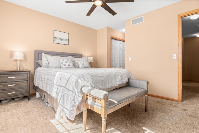 carpeted bedroom with baseboards, a ceiling fan, a closet, and visible vents