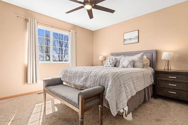 bedroom with baseboards, ceiling fan, visible vents, and light carpet