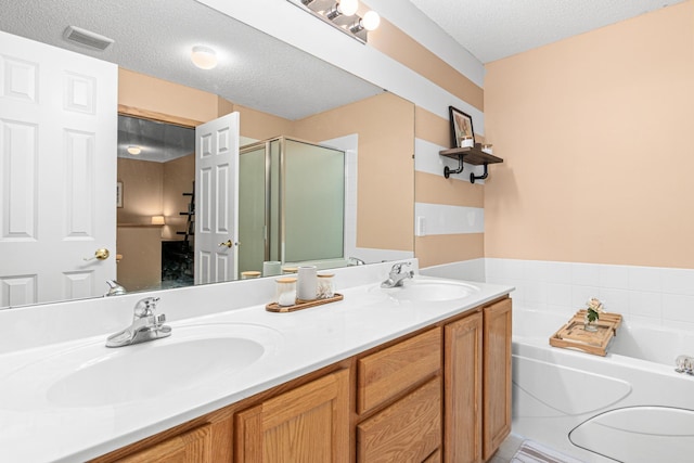 bathroom with visible vents, a sink, a garden tub, and a stall shower
