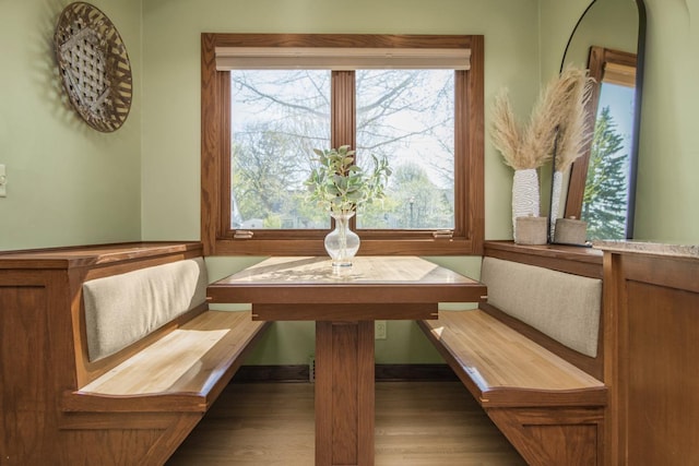 dining space with breakfast area, wood finished floors, and plenty of natural light