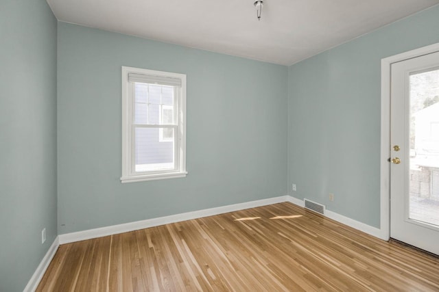 spare room featuring light wood-style flooring and baseboards