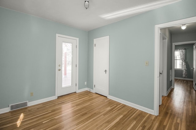 entryway with baseboards and wood finished floors