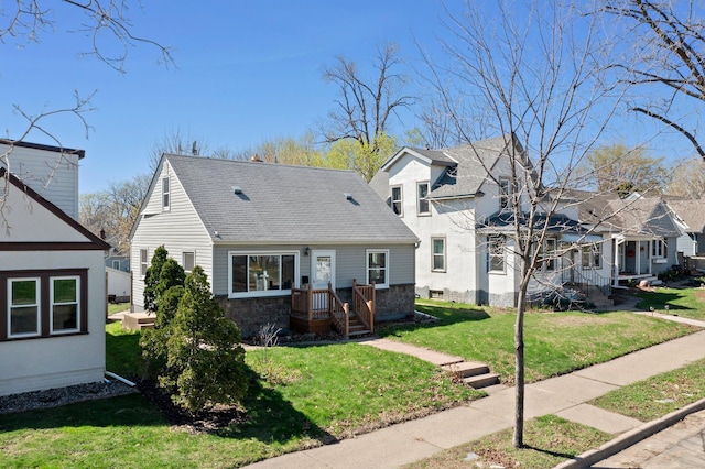 view of front facade featuring stone siding, a residential view, roof with shingles, and a front lawn