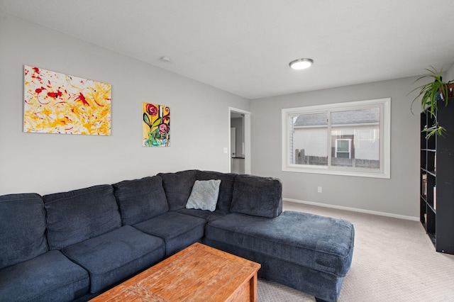 carpeted living room featuring baseboards