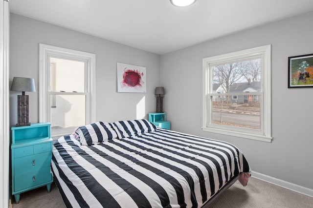 bedroom featuring baseboards and carpet