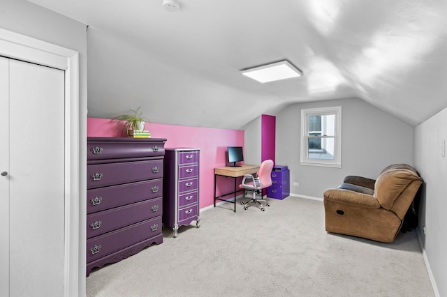 carpeted office space with baseboards and vaulted ceiling