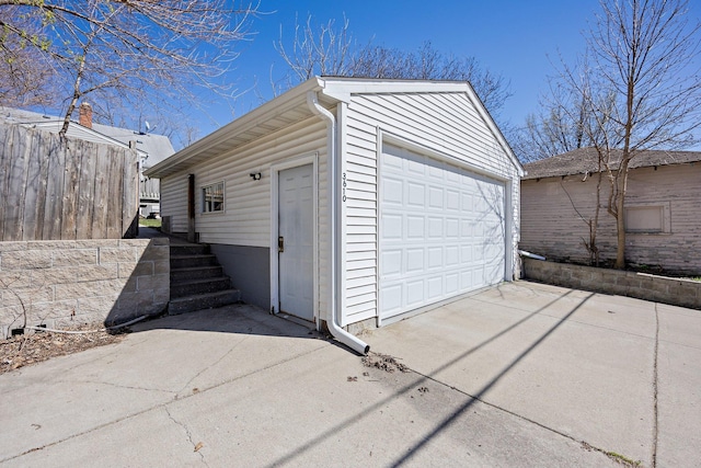 detached garage featuring fence