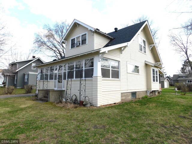 exterior space with a sunroom and a yard