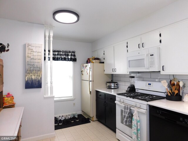 kitchen with light countertops, light tile patterned floors, white cabinets, and white appliances