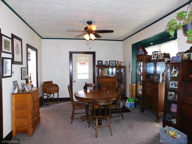 dining space with carpet, ceiling fan, and a wealth of natural light