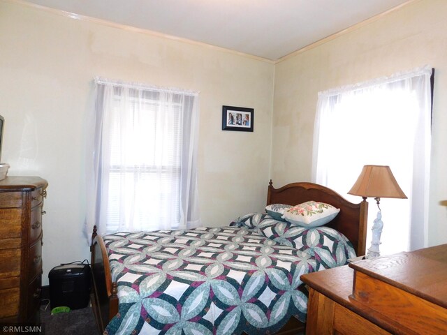 bedroom with ornamental molding