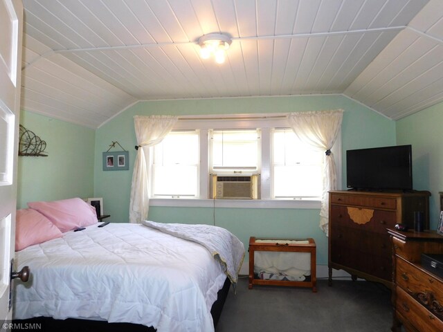 bedroom with carpet, multiple windows, lofted ceiling, and cooling unit