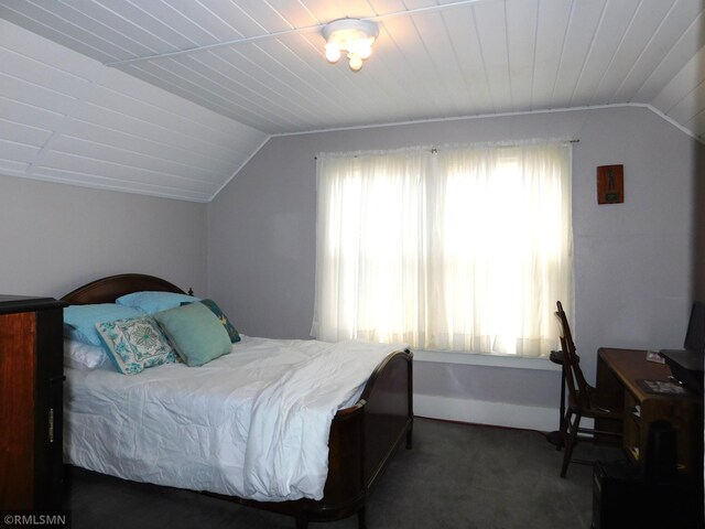 bedroom featuring carpet flooring and vaulted ceiling