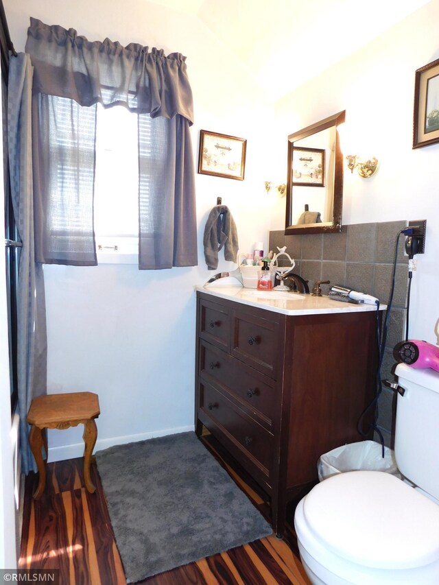 bathroom with vanity, toilet, and wood finished floors