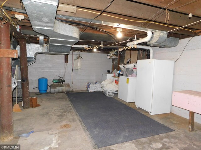 unfinished below grade area with separate washer and dryer and fridge