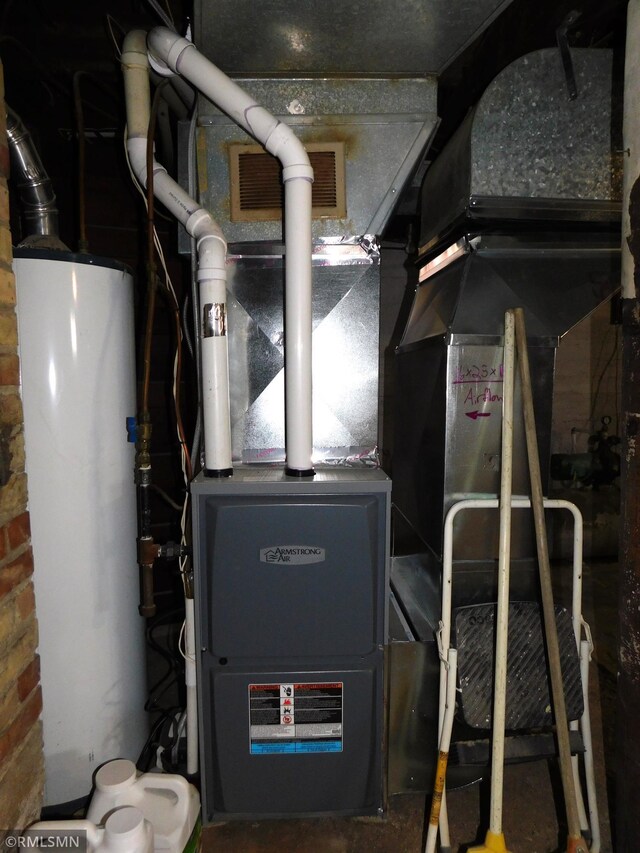 utility room with visible vents and gas water heater
