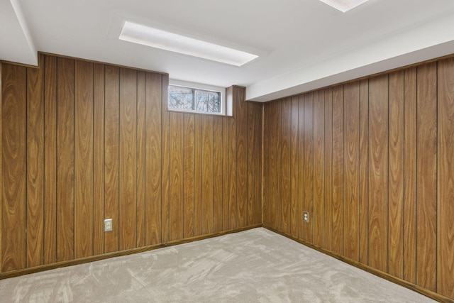 basement with wood walls and carpet flooring