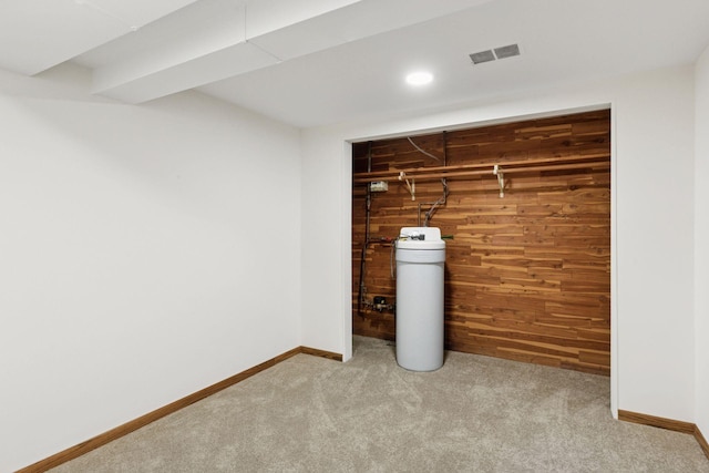 finished below grade area featuring visible vents, recessed lighting, wooden walls, carpet flooring, and baseboards