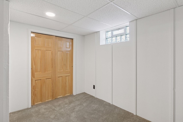 basement featuring carpet flooring, a paneled ceiling, and recessed lighting