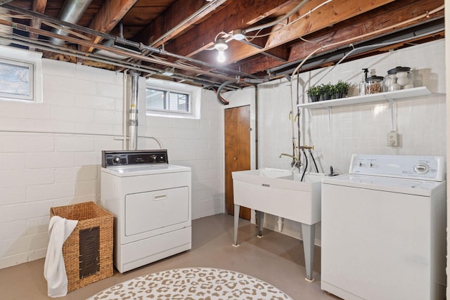 clothes washing area featuring laundry area and washer and clothes dryer