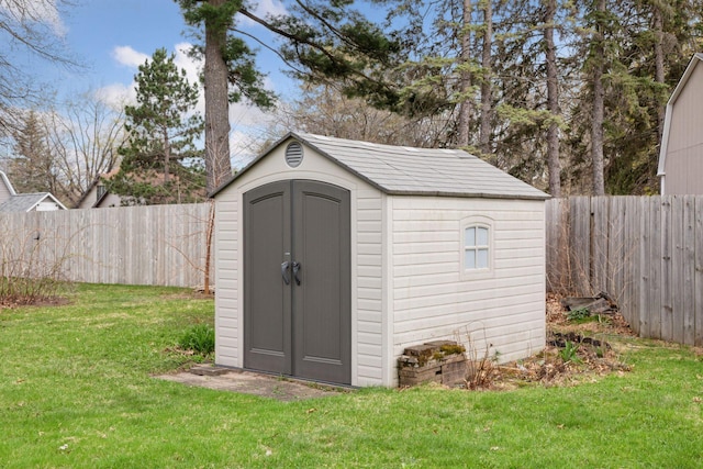 view of shed with a fenced backyard