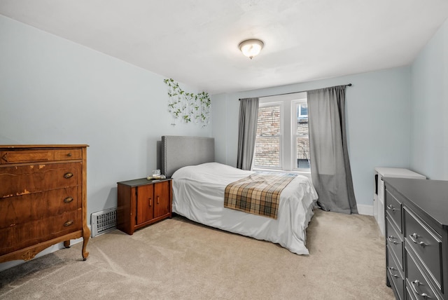 bedroom featuring baseboards, light colored carpet, and visible vents