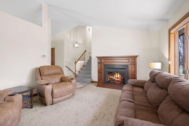 612 19th St N, Sartell, MN 56377 - living area featuring light colored carpet, a glass covered fireplace, vaulted ceiling, and stairs