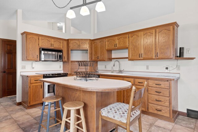 612 19th St N, Sartell, MN 56377 - kitchen with a sink, open shelves, a center island, light countertops, and appliances with stainless steel finishes