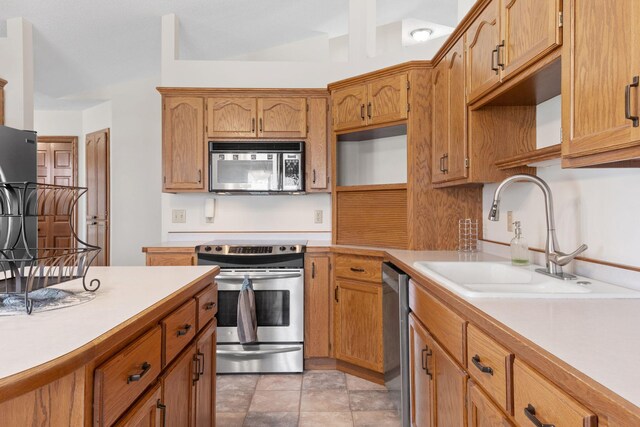 612 19th St N, Sartell, MN 56377 - kitchen featuring brown cabinets, a sink, stainless steel appliances, open shelves, and light countertops