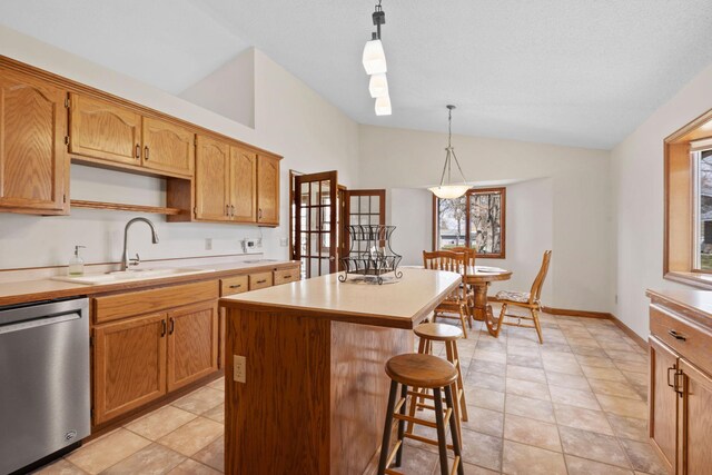 612 19th St N, Sartell, MN 56377 - kitchen featuring stainless steel dishwasher, a kitchen island, vaulted ceiling, a kitchen bar, and a sink