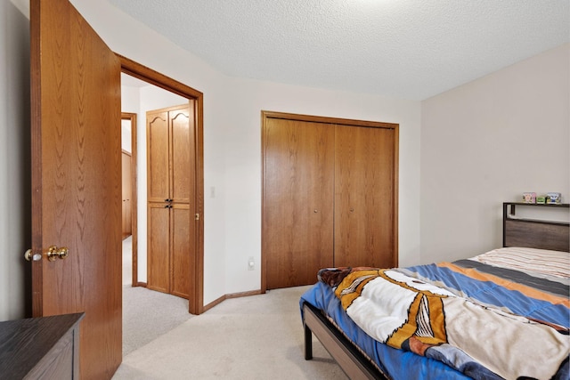 612 19th St N, Sartell, MN 56377 - bedroom featuring baseboards, light colored carpet, a textured ceiling, and a closet