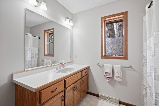 612 19th St N, Sartell, MN 56377 - full bathroom with visible vents, baseboards, vanity, and a healthy amount of sunlight
