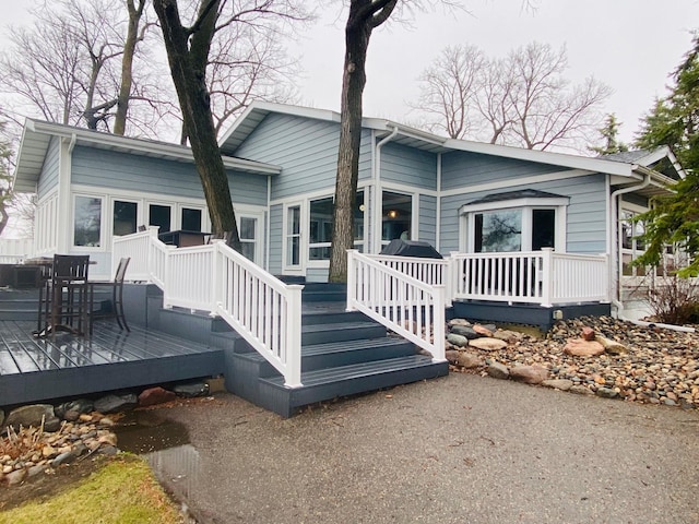 rear view of property featuring a deck