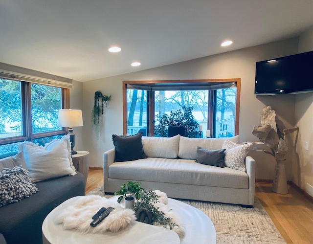 living room with recessed lighting, baseboards, vaulted ceiling, and light wood finished floors