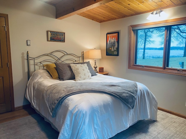 bedroom featuring baseboards, wooden ceiling, and beamed ceiling