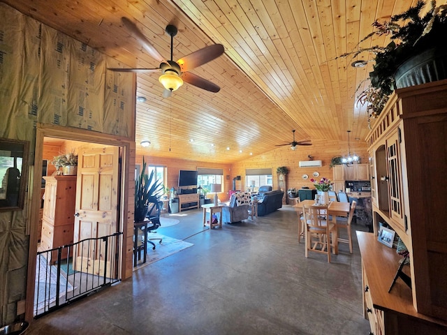 49818 Long Lake Trl, Bigfork, MN 56628 - dining area featuring a ceiling fan, vaulted ceiling, finished concrete flooring, wood ceiling, and wood walls