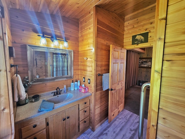 49818 Long Lake Trl, Bigfork, MN 56628 - bathroom with wooden walls, wood ceiling, wood finished floors, and vanity