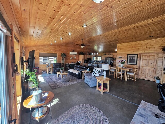 49818 Long Lake Trl, Bigfork, MN 56628 - living area featuring wood walls, ceiling fan, and concrete floors