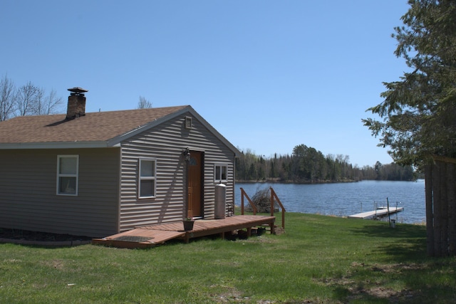 49818 Long Lake Trl, Bigfork, MN 56628 - exterior space with a chimney, a yard, roof with shingles, and a deck with water view