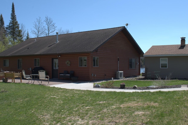 49818 Long Lake Trl, Bigfork, MN 56628 - rear view of house featuring a patio, central AC, a yard, and roof with shingles