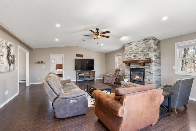 695 Pine Lake Ln, Bone Lake Twp, WI 54837 - living room featuring lofted ceiling, dark wood-style floors, a ceiling fan, baseboards, and a stone fireplace
