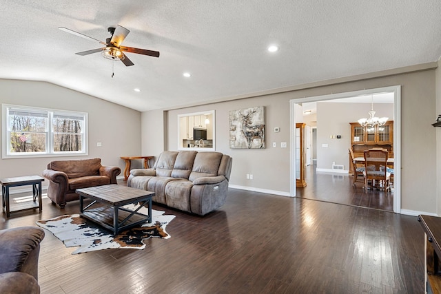 695 Pine Lake Ln, Bone Lake Twp, WI 54837 - living room with lofted ceiling, ceiling fan with notable chandelier, a textured ceiling, dark wood-style flooring, and baseboards